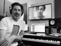 Composer Adrian Walther seated by his piano, crafting royalty free music for ads, podcasts, and social content.